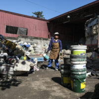 Woman sifts through trash in Phillippines.