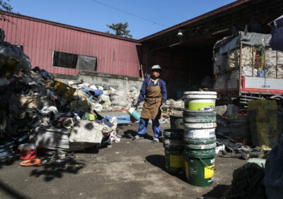 Woman sifts through trash in Phillippines.