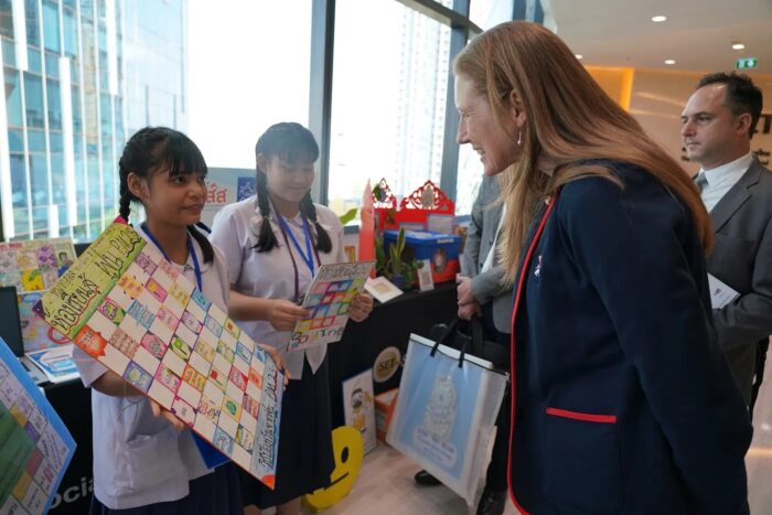 Linda McElroy visiting a student booth at the Climate Action Collaboration Launch event