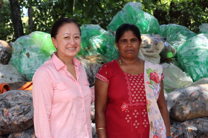 two women smiling, posed for a photo.