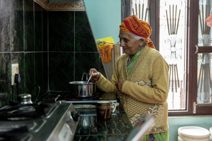 a woman brewing tea on her stove