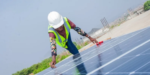 a person doing work on a solar panel