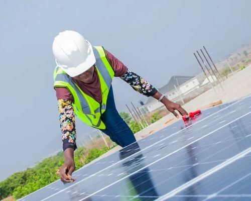 a person doing work on a solar panel