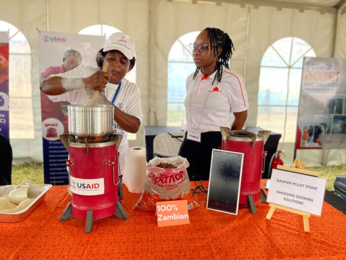 two women cooking with a USAID stove